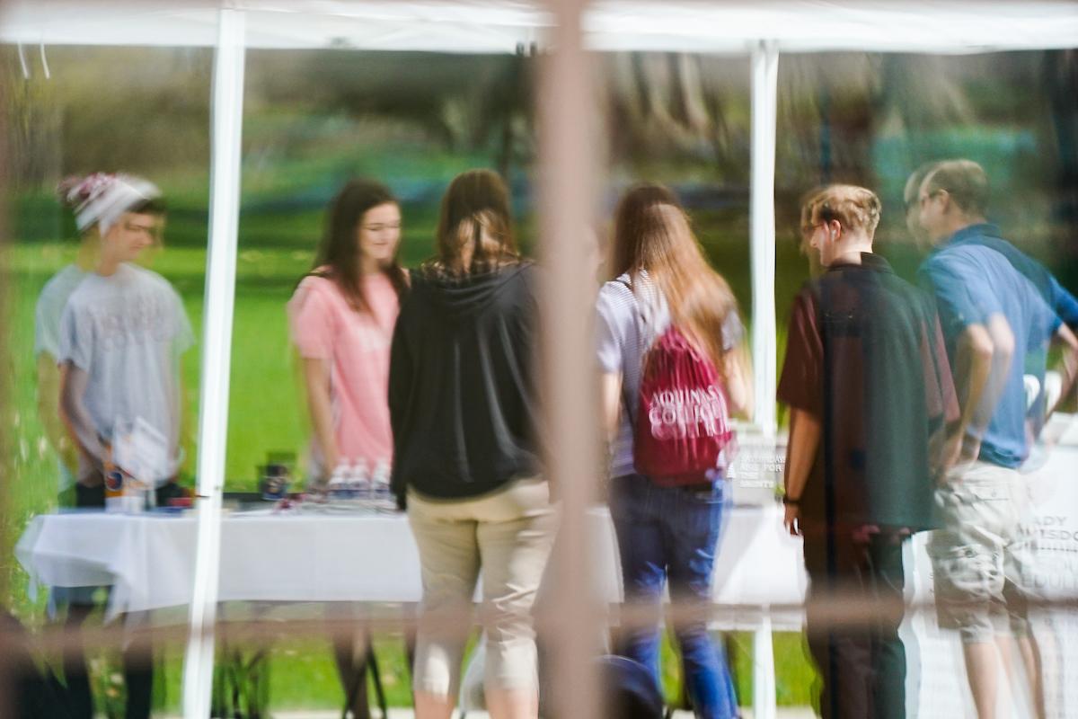Reflection in glass of students at a table talking